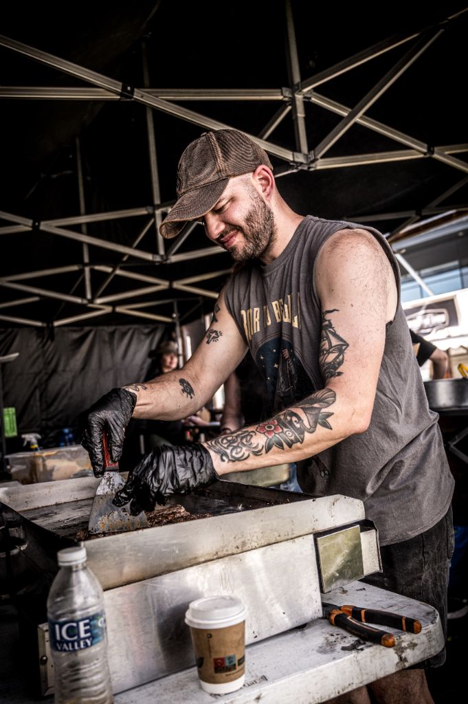 Chef cooking on plancha at a festival event