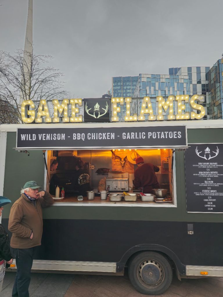 Game and Flames truck close-up showing lit sign and menu